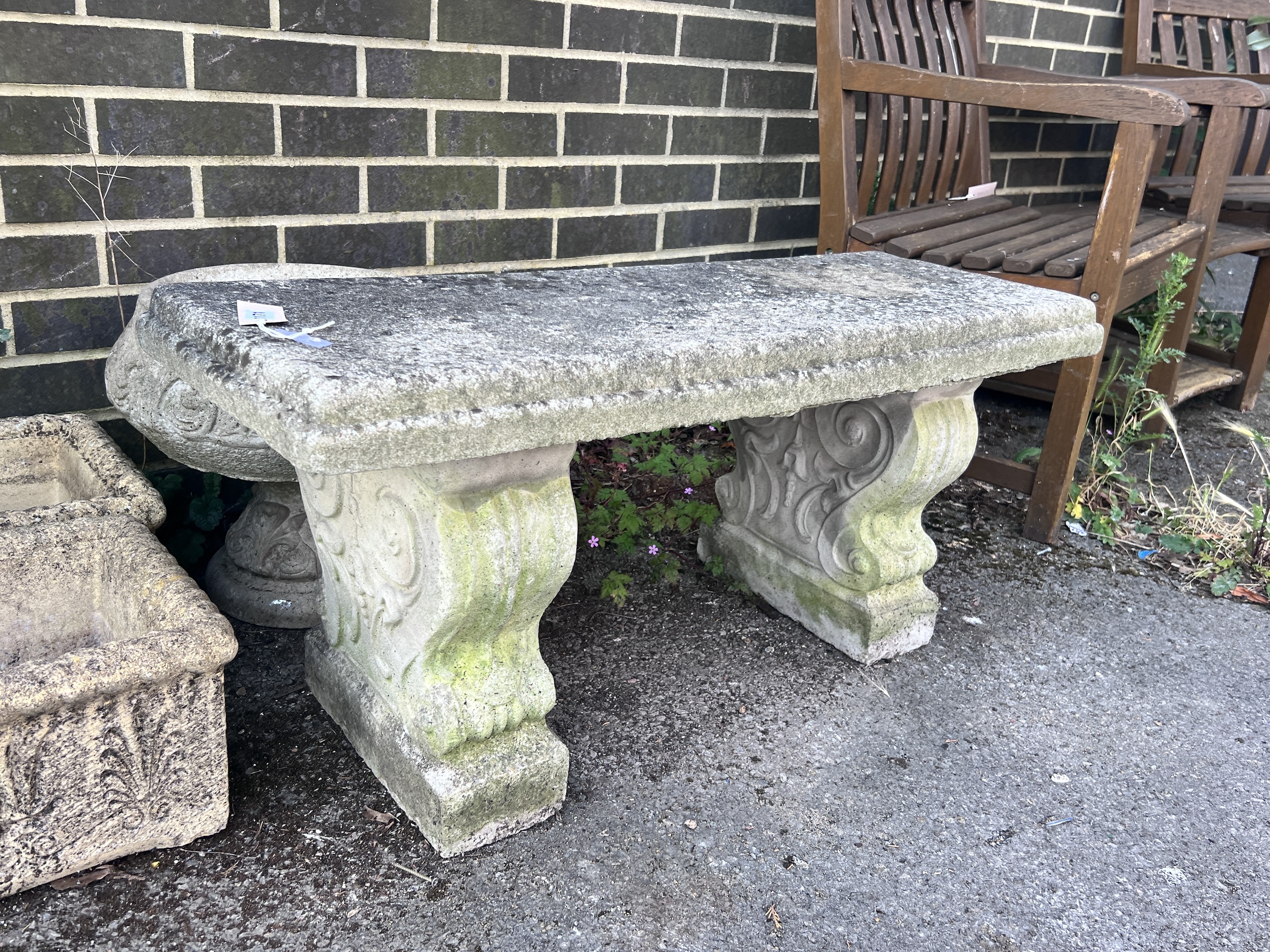 A reconstituted stone garden bench seat, length 98cm, depth 36cm, height 44cm